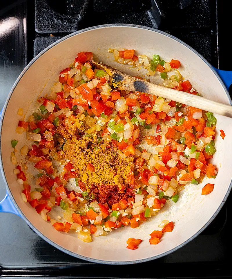 Add turmeric and Kashmiri chili powder