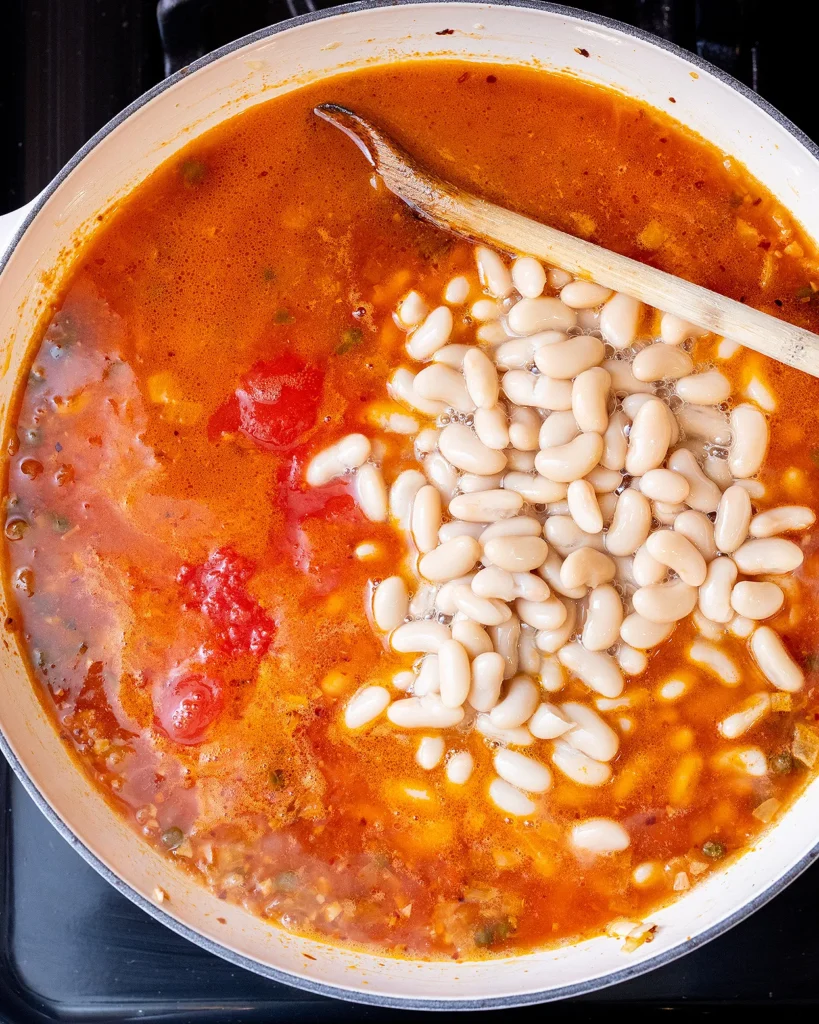 Add beans and crushed tomatoes