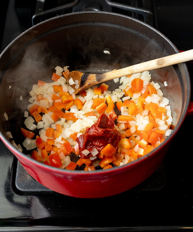 Add tomato paste and garlic