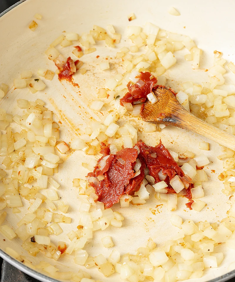 Add tomato paste and garlic